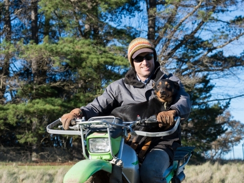 Farmer and his dog on a motorbike