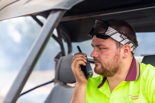 Farmer in buggy talking on two-way radio
