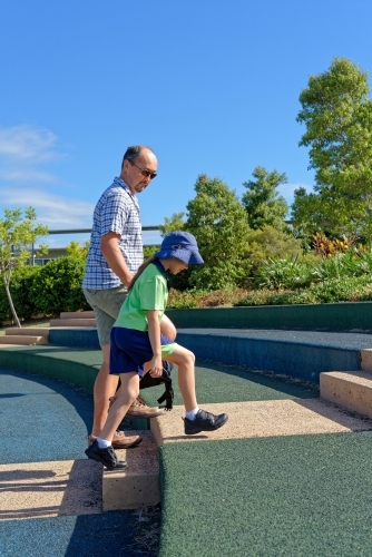 Father and daughter walking to school and class room attending an Australian School - Australian Stock Image