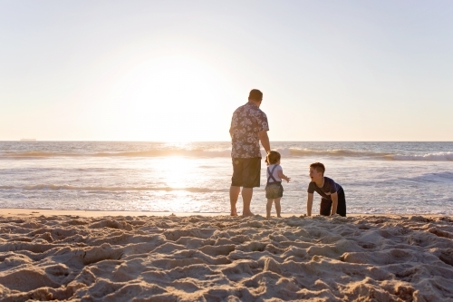 Father And His Two Children At The Beach At Sunset - Australian Stock Image