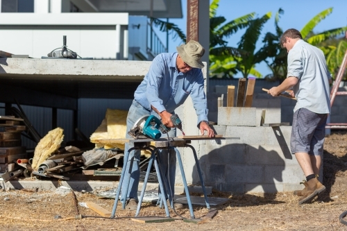 Father and son working together on a building project - Australian Stock Image