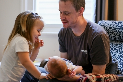 Father showing his little girl her baby brother - Australian Stock Image