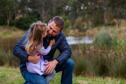 Father talking with his young daughter outside - Australian Stock Image