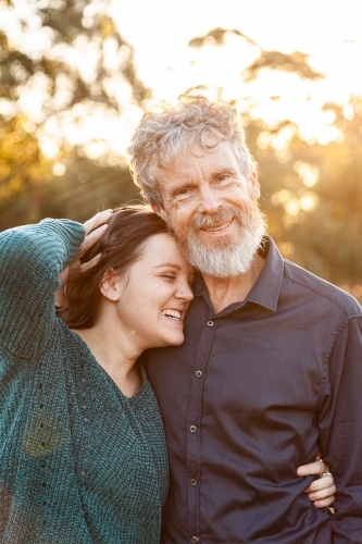 Father with daughter in afternoon light - Australian Stock Image
