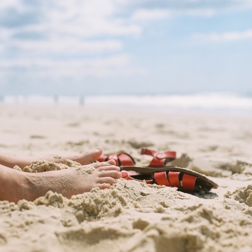 Feet in the sand at the beach