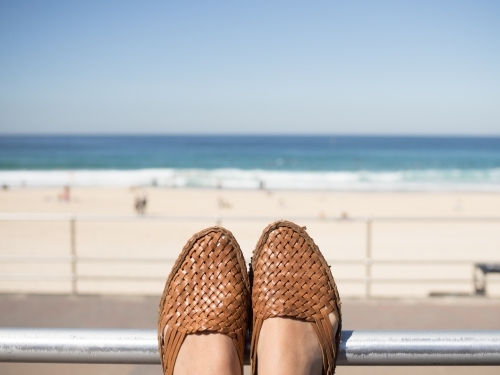 Feet resting whilst looking at the beach