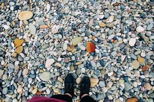 Feet standing on rocks - Australian Stock Image