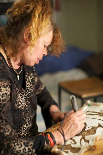 Female Aboriginal Artist at Work on Possum Skin - Australian Stock Image