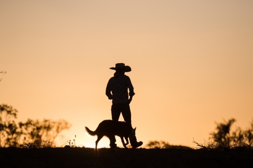 Female farmer and dog silhouette - Australian Stock Image