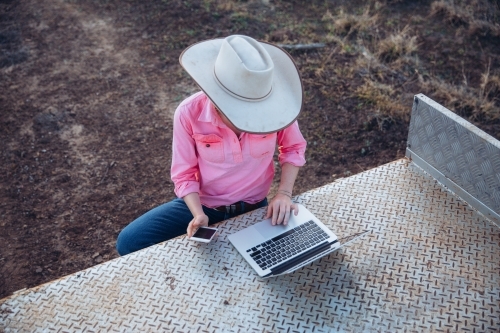 Female farmer using telecommunications device - Australian Stock Image