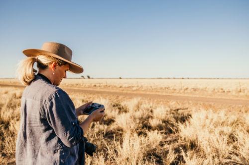 Female flying drone in rural Australia - Australian Stock Image