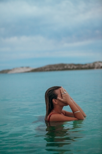 Female in ocean at sunset - Australian Stock Image