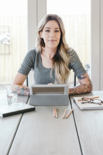 Female looking accomplished with her work - Australian Stock Image