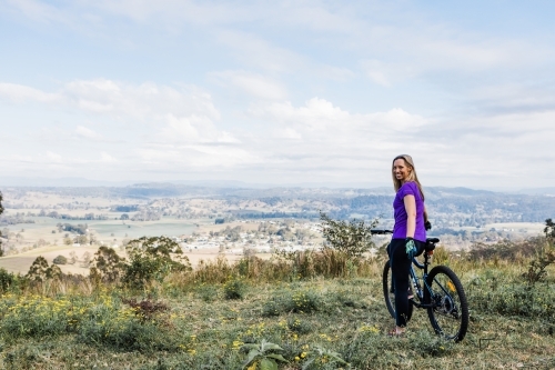 female mountain biker on top of the hill