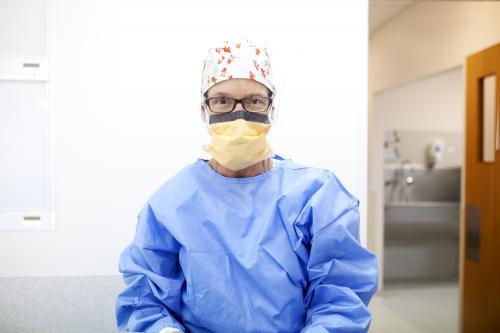 Female nurse dressed in protective clothing ready to perform surgery - Australian Stock Image