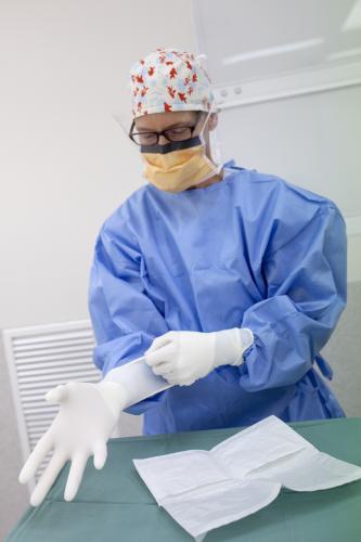 Female nurse dressed in protective clothing ready to perform surgery - Australian Stock Image