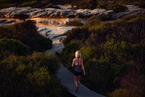 Female runner Morning Cliffside - Australian Stock Image