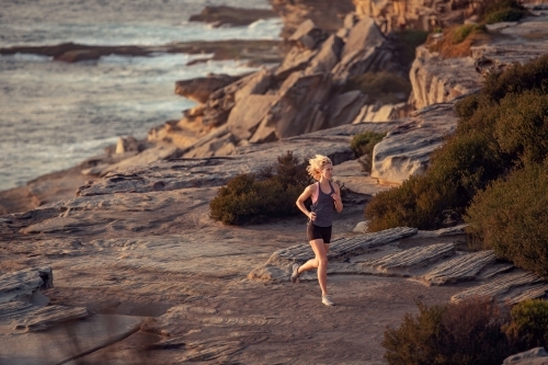 Female runner Morning Cliffside - Australian Stock Image