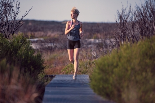 Female runner Morning Cliffside - Australian Stock Image