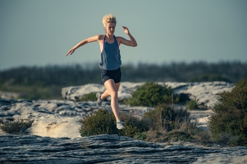 Female runner Morning Cliffside - Australian Stock Image