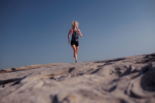 Female runner Morning Cliffside - Australian Stock Image