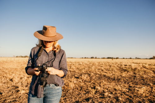 Female standing looking at camera on farm - Australian Stock Image