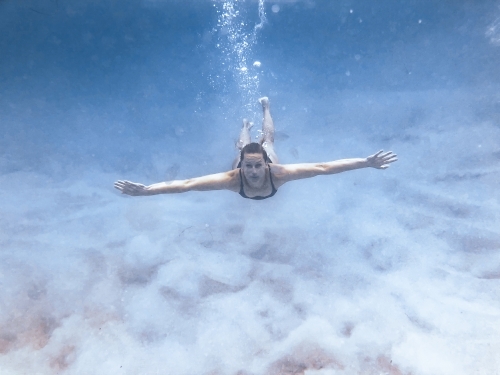 Female swimming underwater in the ocean - Australian Stock Image