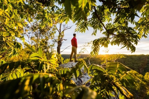 figure on rock at sunrise - Australian Stock Image