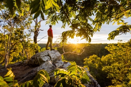 figure on rock at sunrise - Australian Stock Image