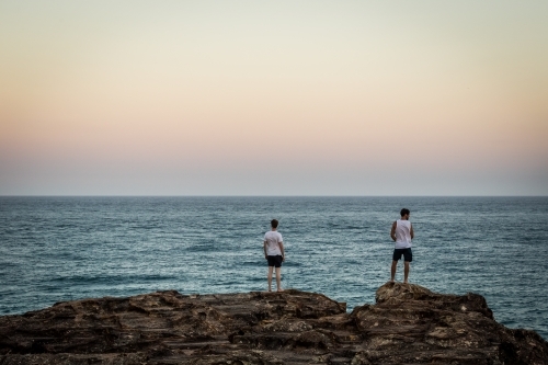 Figures overlooking the ocean - Australian Stock Image
