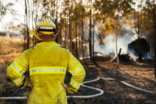 Fire and rescue man in fire brigade out at a grass fire emergency site - Australian Stock Image