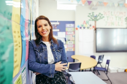 First Nations public school teacher smiling at the camera in classroom