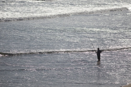 Fisherman standing in water