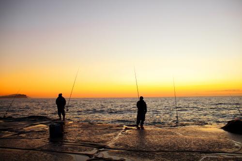 Fishermen on a rock platform - Australian Stock Image