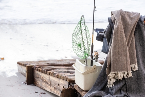 Fishing supplies on a fold-out chair on the beach - Australian Stock Image