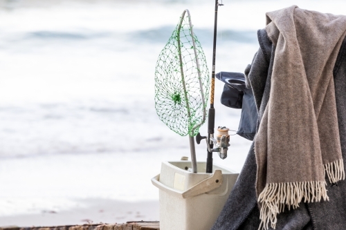 Fishing supplies on a fold-out chair on the beach - Australian Stock Image