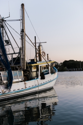 Fishing Trawler on a river at dusk - Australian Stock Image
