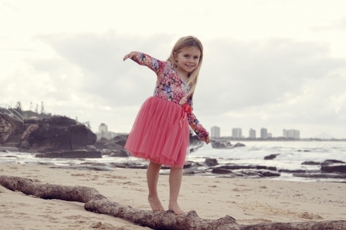 Five year old balancing old log - Australian Stock Image