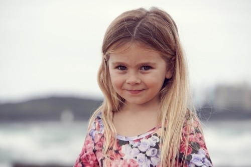 Five year old girl with blonde hair smiling - Australian Stock Image