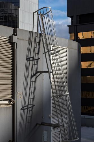 Fixed ladder on top of skyscraper - Australian Stock Image