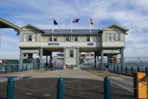 flags flying over Station Pier building, passenger shipping - Australian Stock Image