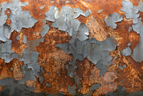Flaking paint and rust on a water supply pipe. - Australian Stock Image