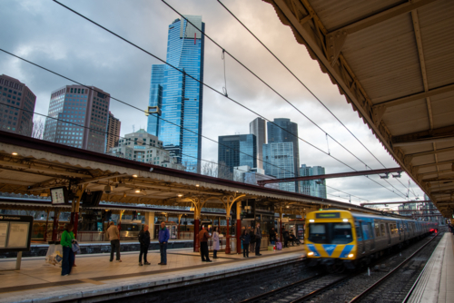 Flinders street station platforms with train in motion - Australian Stock Image