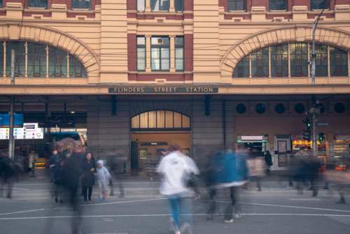Flinders Street Station with pedestrians crossing the road - Australian Stock Image