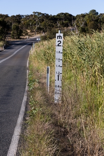 Flood Marker on Rural Road - Australian Stock Image