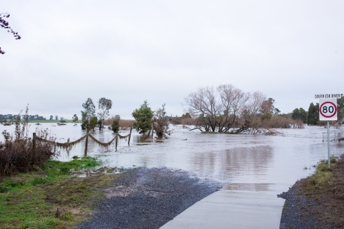 Flood waters covering road - Australian Stock Image