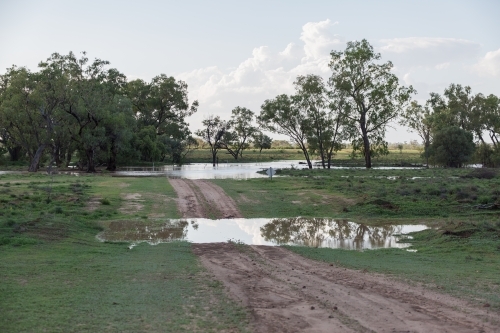 Flooded creek over road - Australian Stock Image