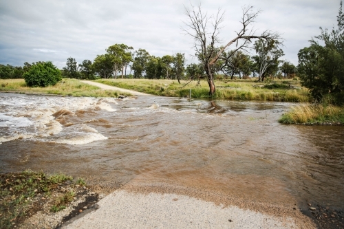 Flooded river crossing on farm - Australian Stock Image