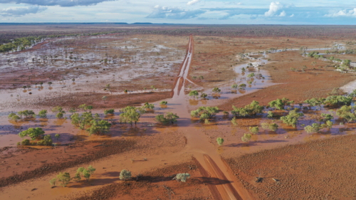 Flooding creeks across the main road - Australian Stock Image