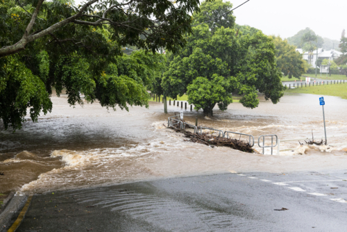 Floodwaters cover a bridge over the Ithaca Creek in the suburb of Red Hill in Brisbane - Australian Stock Image